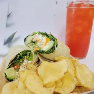 Potato chips and sliced roll and cool drink