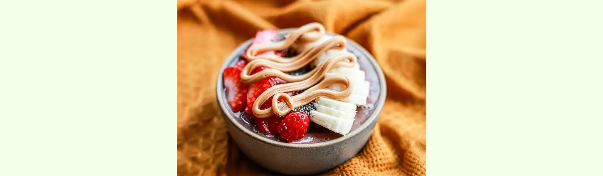 A bowl of food with strawberries and bananas.