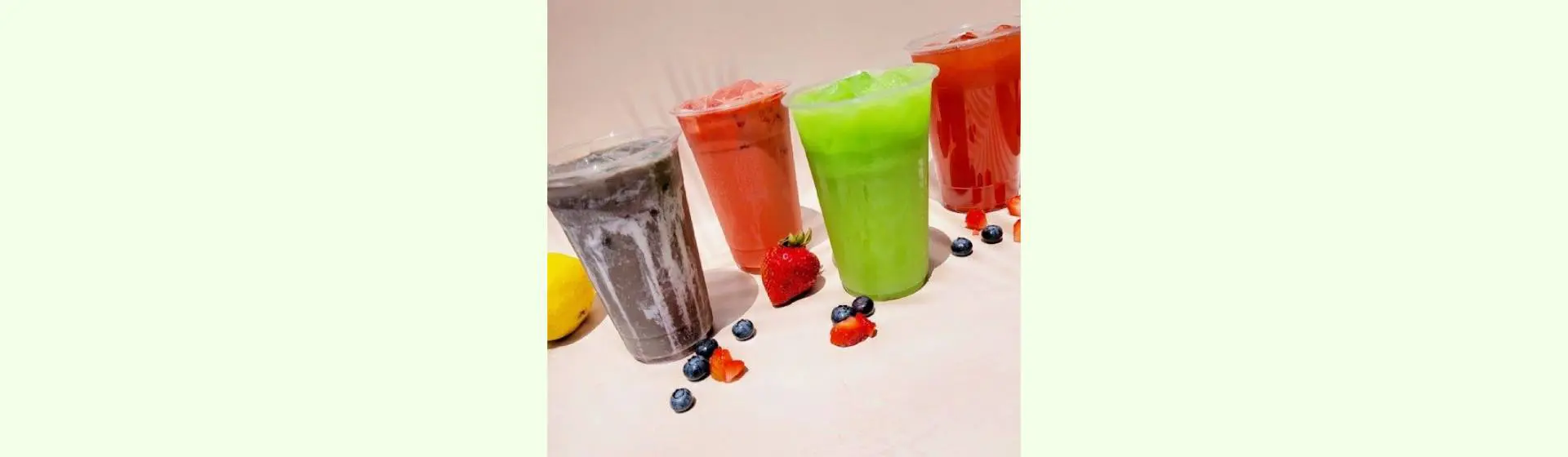 A group of four smoothies sitting on top of a table.